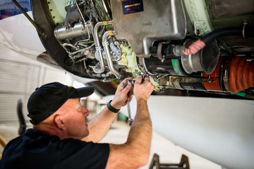 Mechanic performing aircraft maintenance at Taughannock Aviation